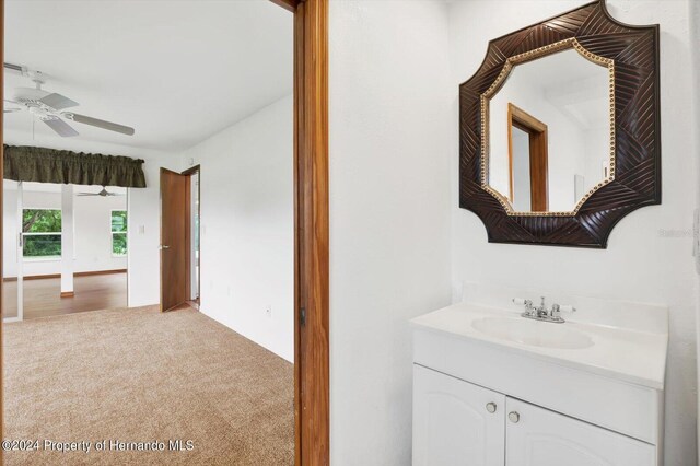 bathroom with ceiling fan and vanity