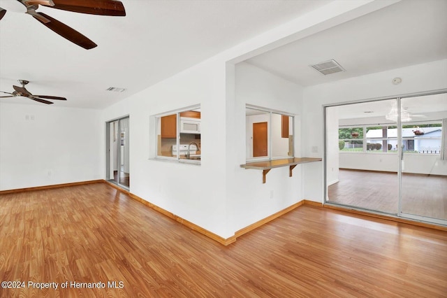 empty room featuring ceiling fan, wood-type flooring, and sink