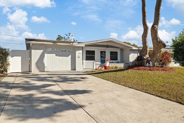 ranch-style home featuring a front lawn and a garage