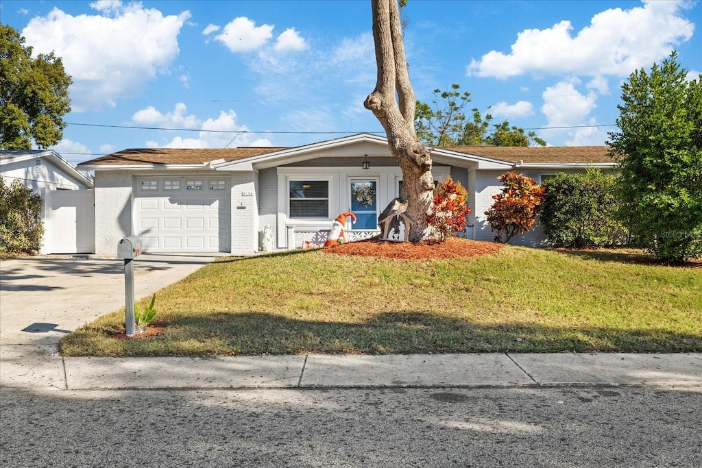 ranch-style home featuring a garage and a front yard