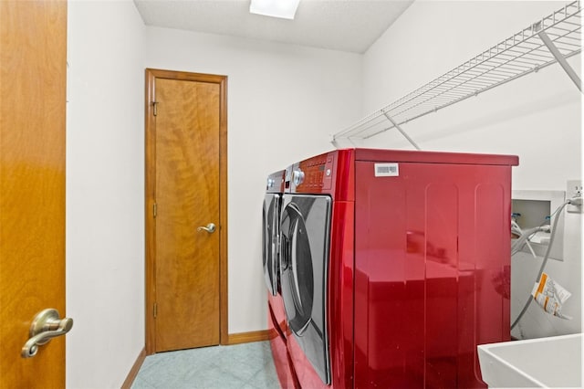 clothes washing area featuring washing machine and clothes dryer