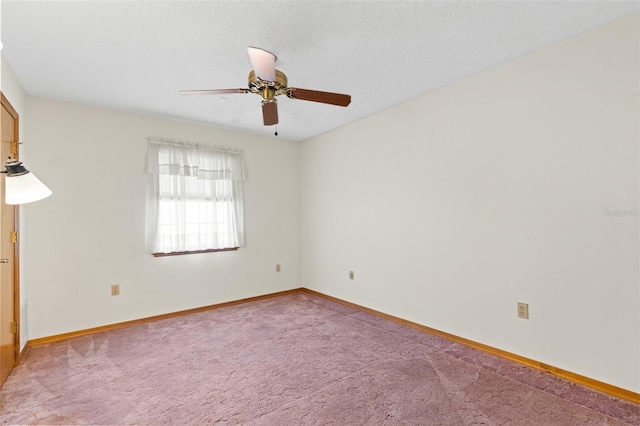 carpeted spare room with a textured ceiling and ceiling fan