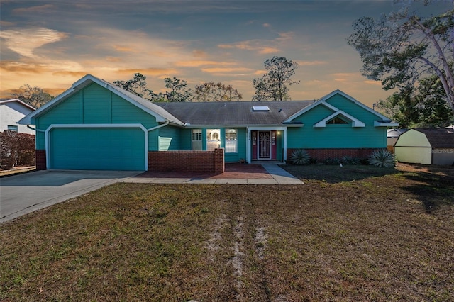 ranch-style home featuring a lawn and a garage