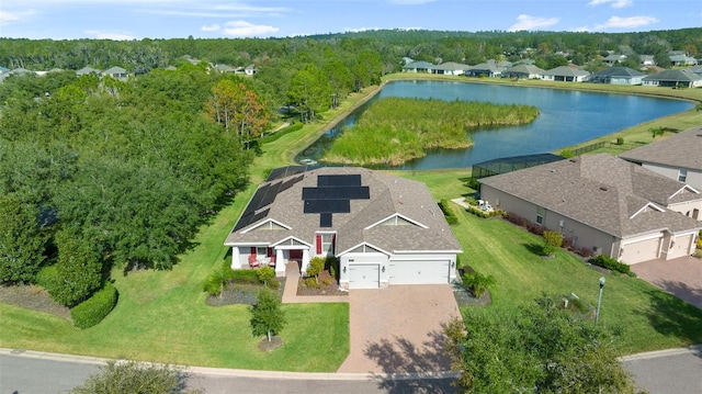 birds eye view of property with a water view