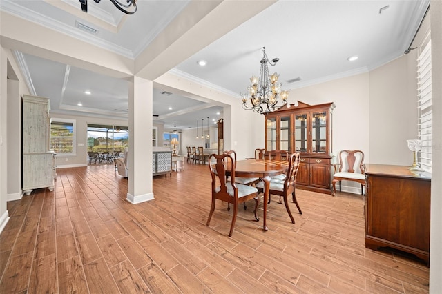 dining area with crown molding and a chandelier