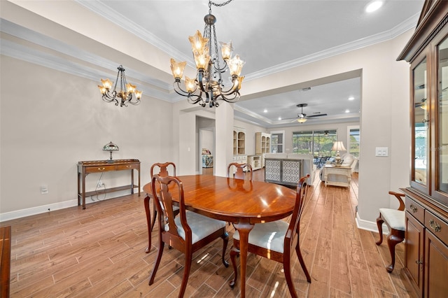 dining area with ceiling fan with notable chandelier and ornamental molding