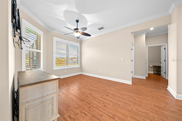 unfurnished room featuring ceiling fan, light hardwood / wood-style flooring, and ornamental molding