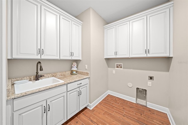 clothes washing area featuring cabinets, hookup for a washing machine, gas dryer hookup, electric dryer hookup, and sink