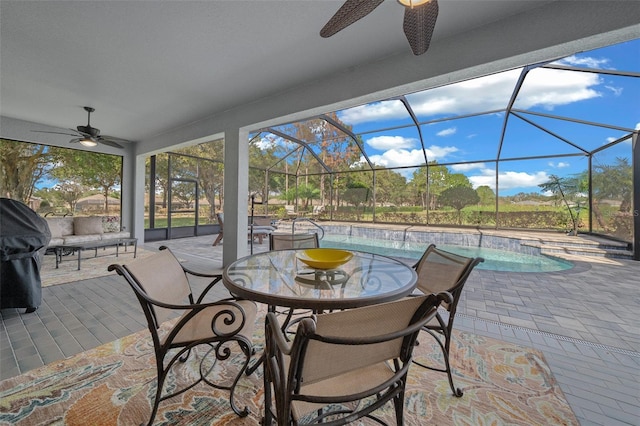 view of patio featuring glass enclosure and ceiling fan