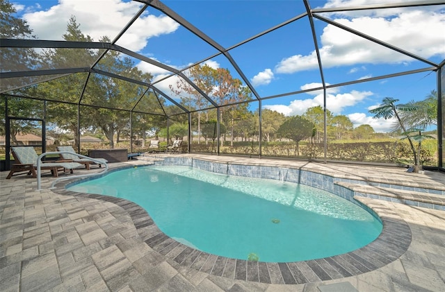 view of pool with glass enclosure and a patio