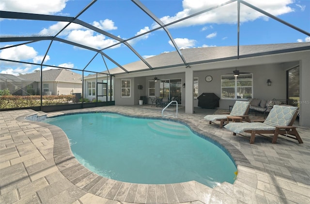 view of swimming pool featuring glass enclosure, ceiling fan, a patio area, and a grill