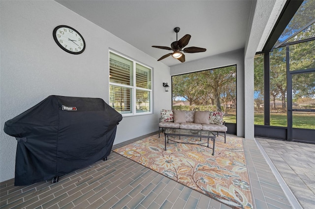 sunroom / solarium featuring ceiling fan