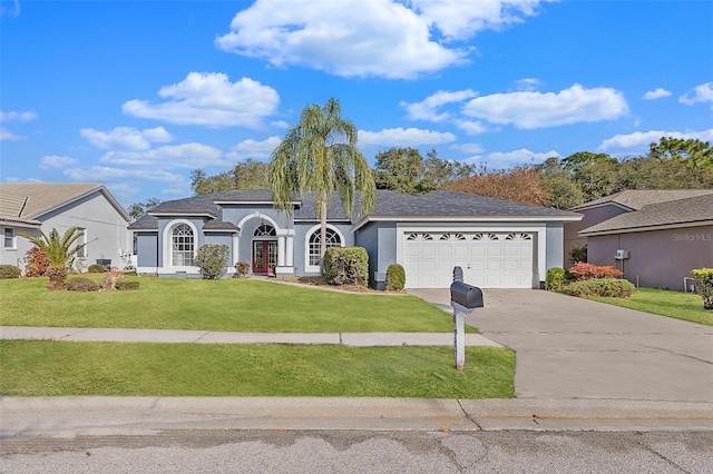 single story home featuring a front lawn and a garage