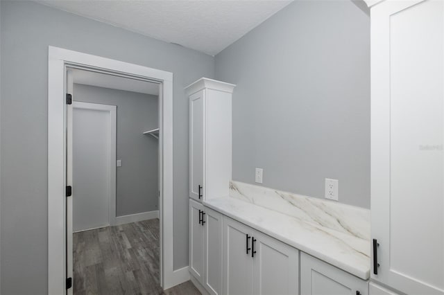 bathroom with a textured ceiling and hardwood / wood-style floors