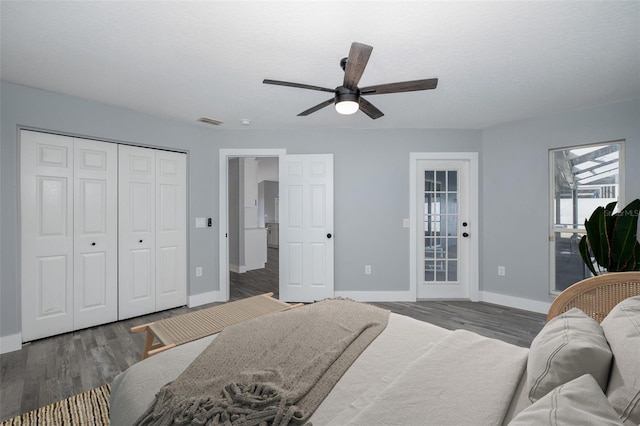 bedroom featuring a textured ceiling, dark wood-type flooring, access to exterior, a closet, and ceiling fan