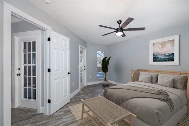 bedroom featuring ceiling fan, hardwood / wood-style floors, access to outside, and a textured ceiling