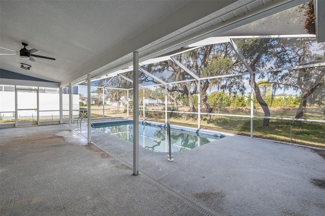 view of swimming pool with a patio and glass enclosure