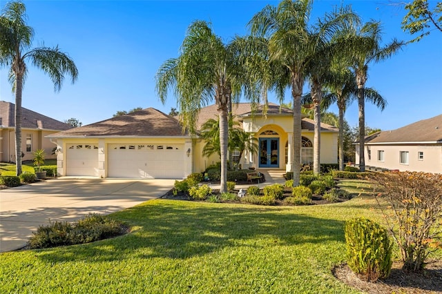 view of front facade featuring french doors, a front yard, and a garage