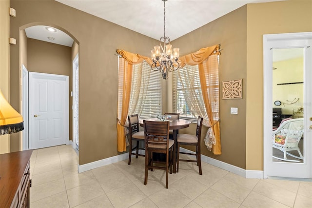 dining area with light tile patterned flooring and a notable chandelier