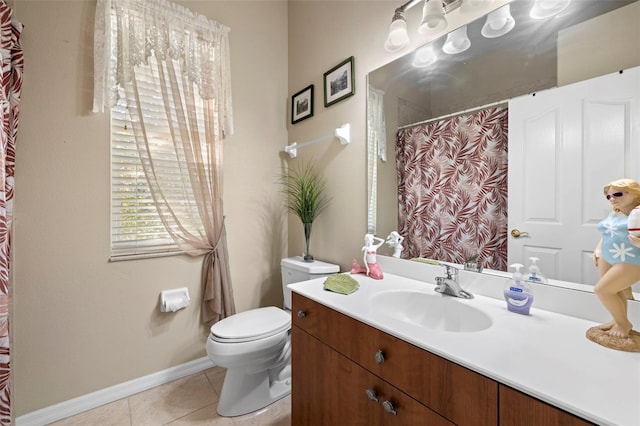 bathroom featuring tile patterned flooring, vanity, and toilet