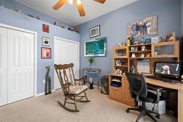 carpeted office space featuring ceiling fan