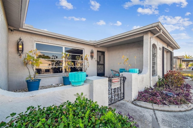 view of exterior entry with a garage