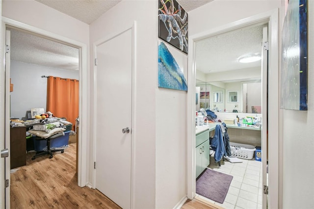 bathroom with vanity, hardwood / wood-style floors, and a textured ceiling