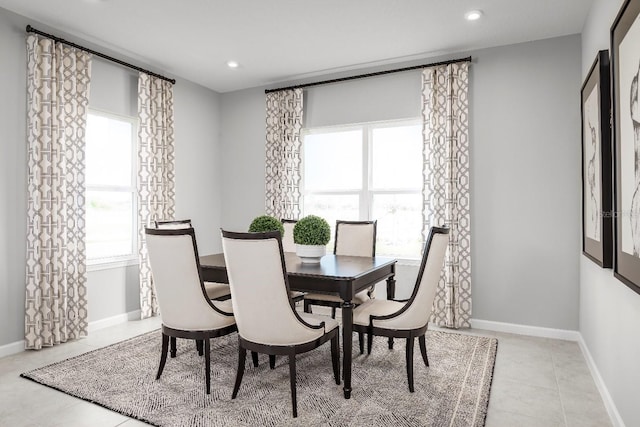 tiled dining space featuring a wealth of natural light