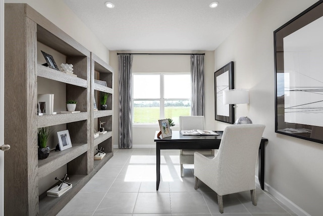 office area with light tile patterned flooring and a textured ceiling