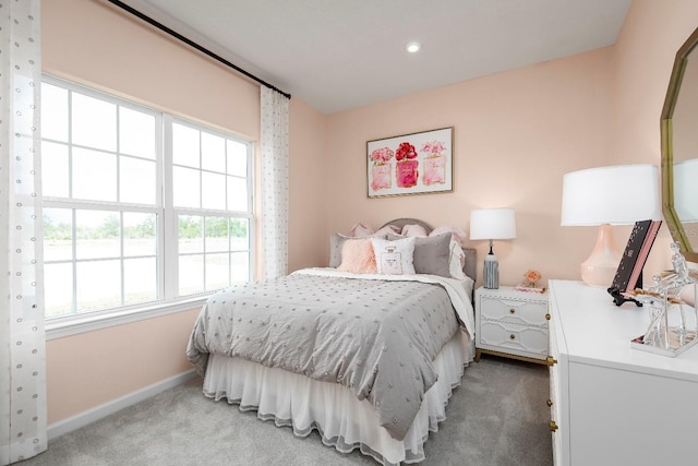 carpeted bedroom featuring multiple windows