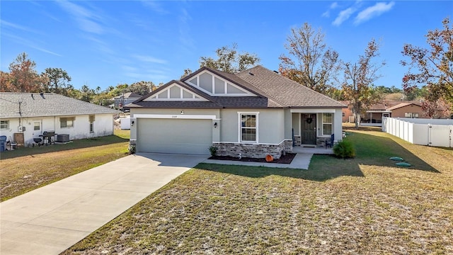 view of front of house with central AC, a front yard, and a garage