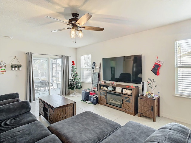 living room with ceiling fan, a healthy amount of sunlight, and light tile patterned floors