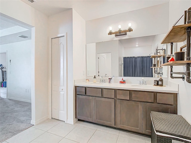 bathroom with tile patterned flooring and vanity