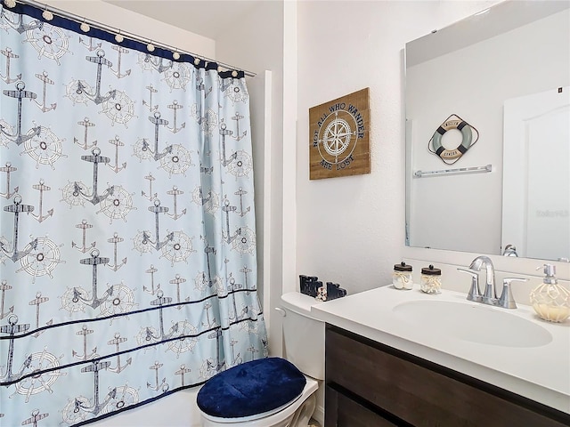 bathroom with walk in shower, vanity, and toilet