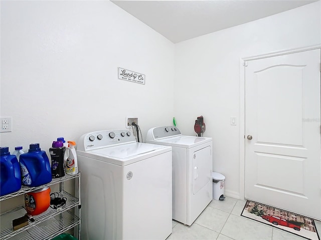 washroom featuring independent washer and dryer and light tile patterned floors