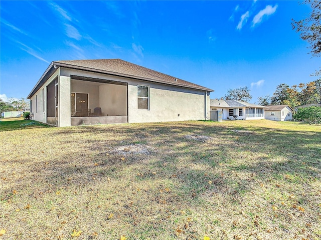 back of property featuring a sunroom, a yard, and cooling unit