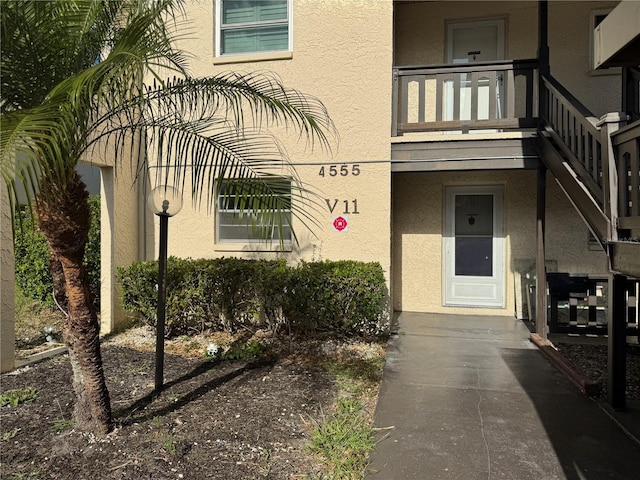 view of exterior entry with a balcony