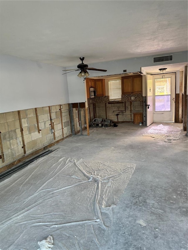 interior space with ceiling fan