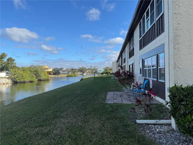 view of yard featuring a patio area and a water view