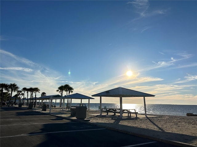 exterior space featuring a water view and a beach view