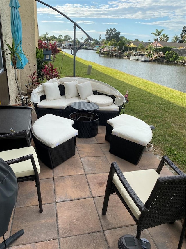 view of patio / terrace with an outdoor hangout area and a water view