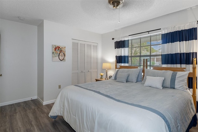 bedroom featuring dark hardwood / wood-style flooring, a closet, and a textured ceiling