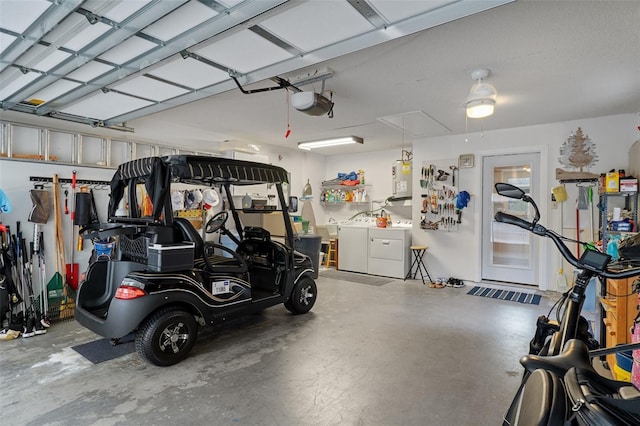 garage featuring independent washer and dryer and a garage door opener