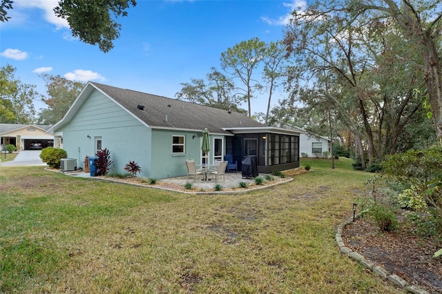 back of house featuring a sunroom, a patio area, a yard, and central AC