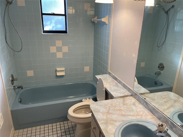 full bathroom featuring tile patterned flooring, vanity, tiled shower / bath combo, and toilet