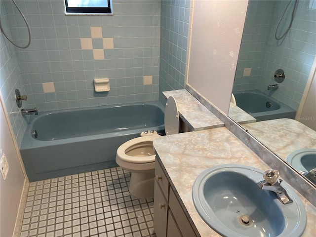 full bathroom with tile patterned flooring, tiled shower / bath combo, toilet, and vanity