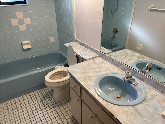 full bathroom with tile patterned flooring, vanity, toilet, and tiled shower / bath