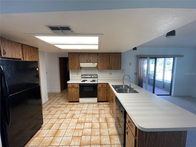 kitchen featuring light tile patterned floors, sink, a textured ceiling, and black appliances