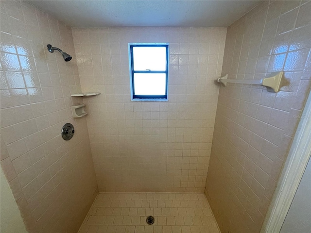 bathroom with tiled shower