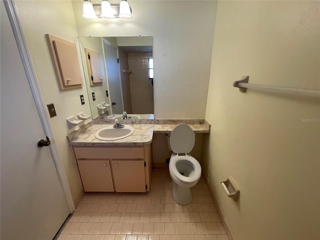 bathroom featuring tile patterned floors, vanity, and toilet